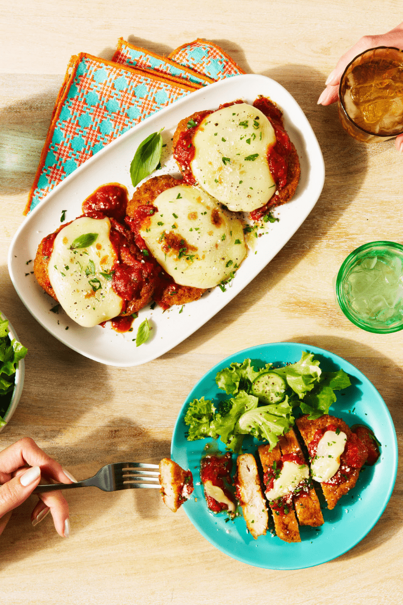 Tablescape of chicken parm and a salad